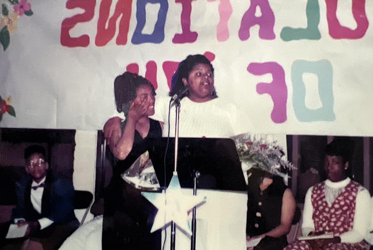 Two gals at the pulpit on graduation day